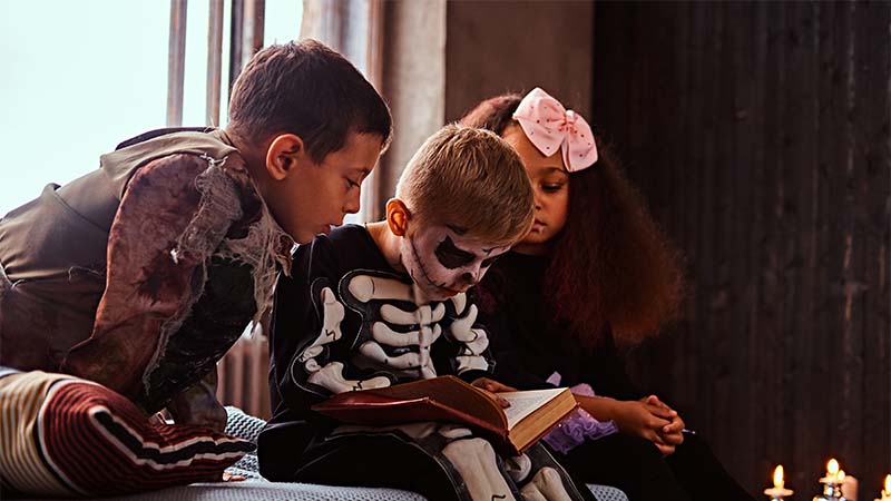 Kids reading horror book